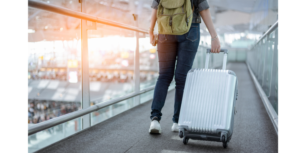 FIFO worker walks through airport with luggage